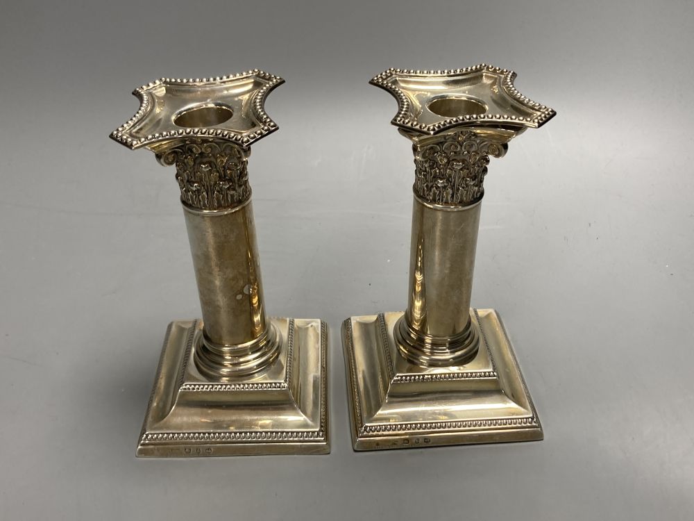 A pair of late Victorian silver dwarf candlesticks, Henry Matthews, Birmingham, 1895, 14.2cm, weighted.